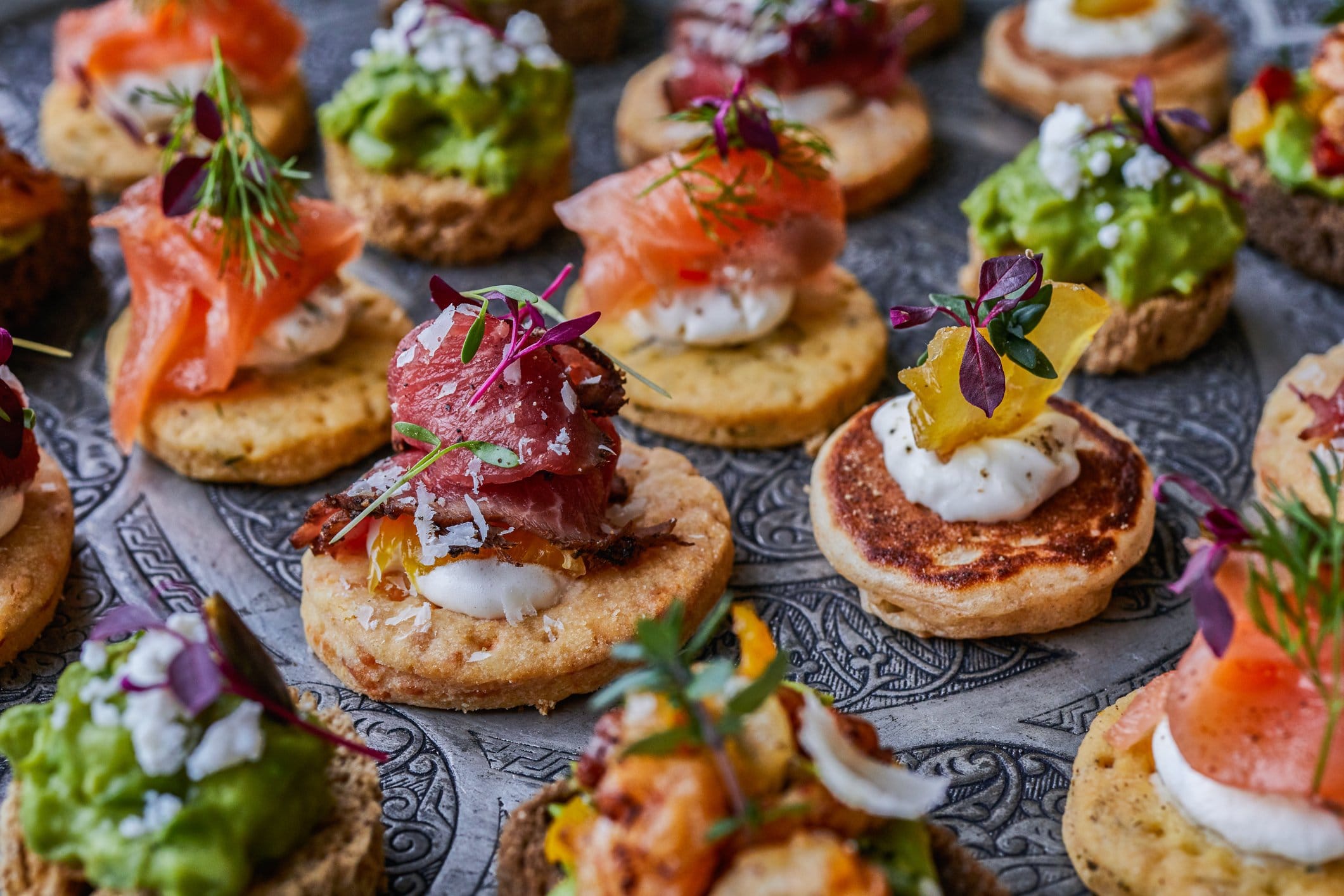 Assorted canapés with smoked salmon, avocado and tuna