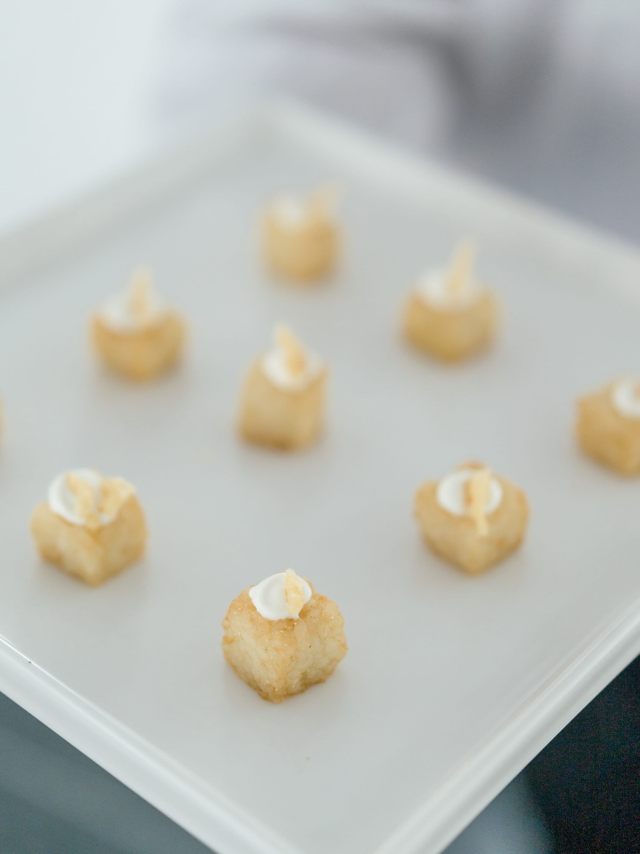 Bite-sized canapés on a white plate at a wedding